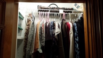 Top row of hanging clothes in my organized tiny closet.