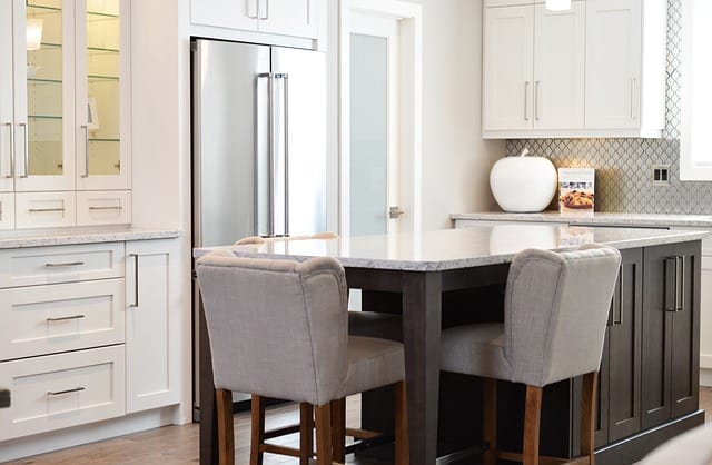 Beautiful decluttered kitchen with white and black cabinets.