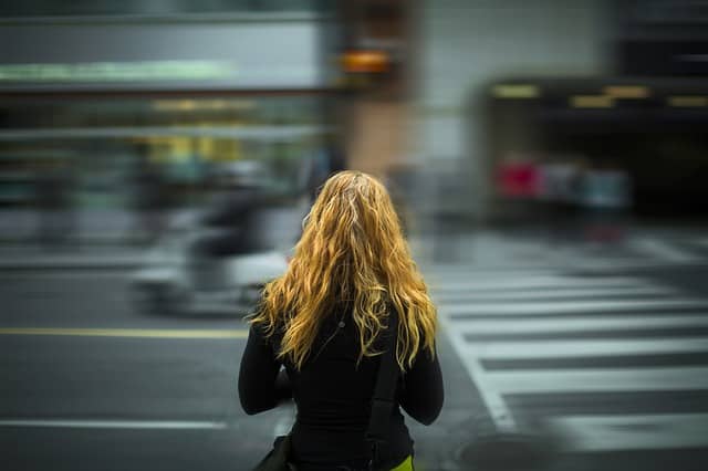 woman looking at busy street