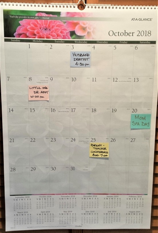 calendar with large spaces for sticky notes - located next to refrigerator command center