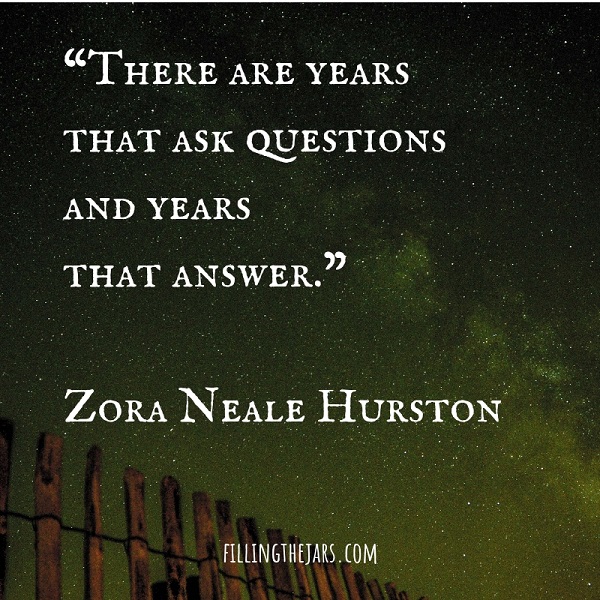 Zora Neale Hurston inspirational quote text on image of green-tinted night sky and wood fence pickets