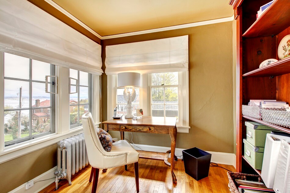 bright and clutter-free home office with windows white chair wood desk wood floor and shelves