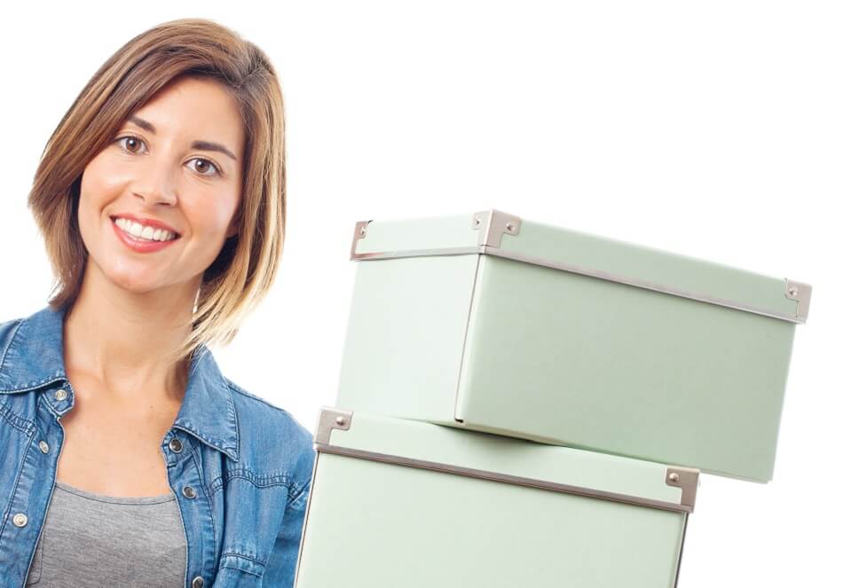 smiling woman holding decorative white boxes for clutter storage