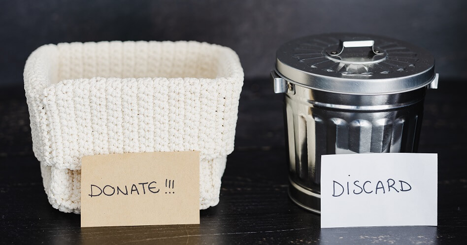 white donate basket and shiny metal discard can on dark background