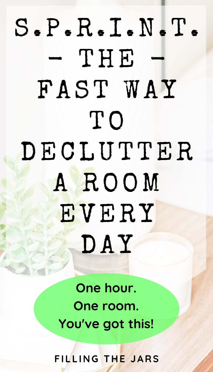 plant and candle on wood table with white overlay and text the fast way to declutter a room