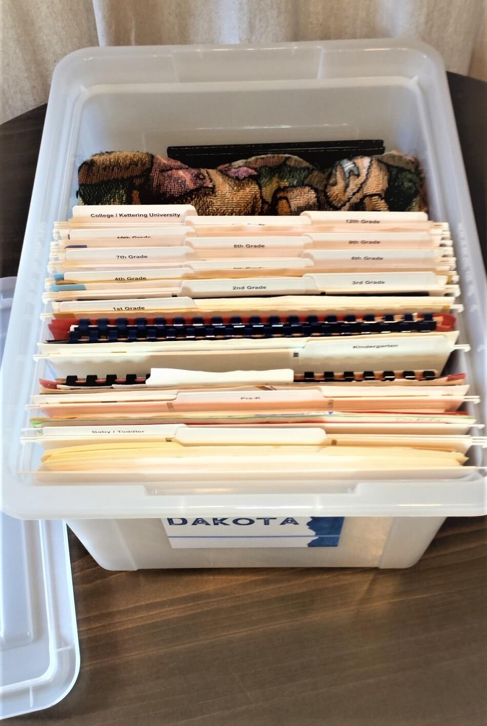 white memory box with organized school papers in white files