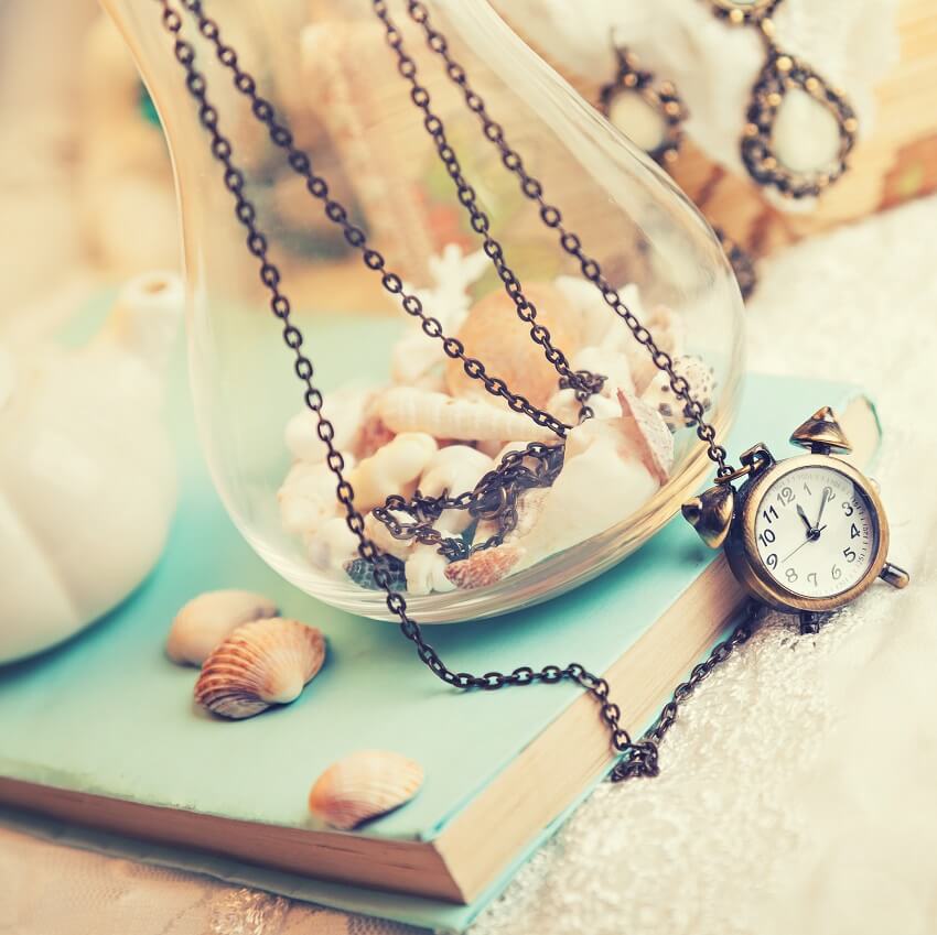 sentimental book, shells, jewelry on white background