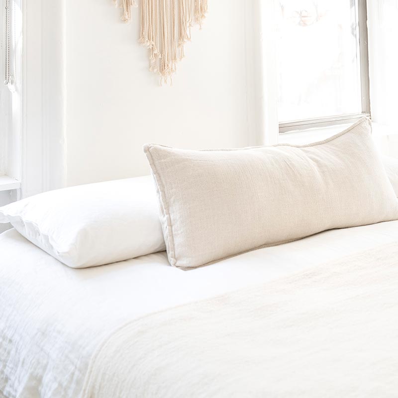 minimalist white bedroom with white bedding and white walls