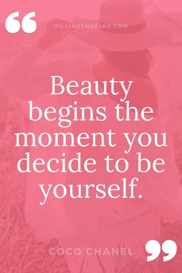 Coco Chanel beauty begins quote in white text on dark pink background over image of woman in white dress and hat standing in grass