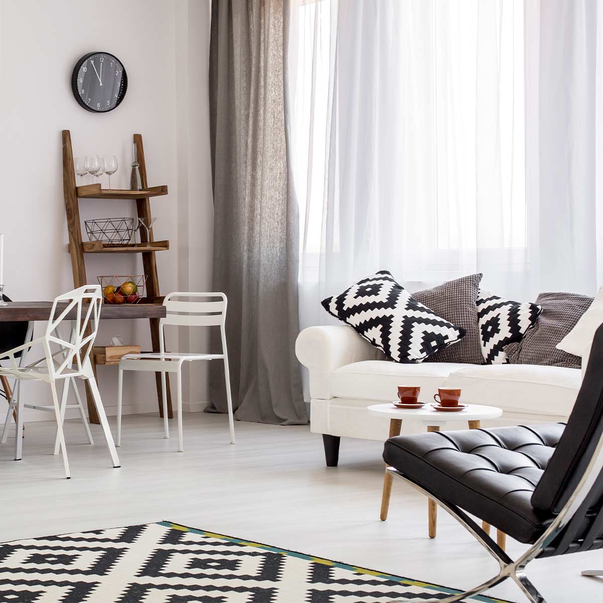 beautiful clutter-free room in neutral shades of black and white and gray with wood accents