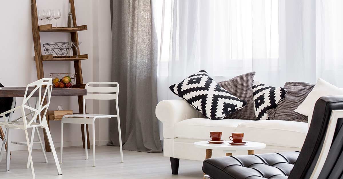 gorgeous clutter-free living room with white couch and neutral decor