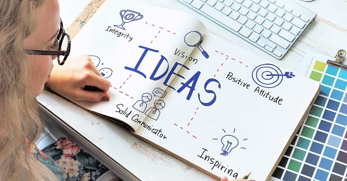 Woman working on creative mind map journal.