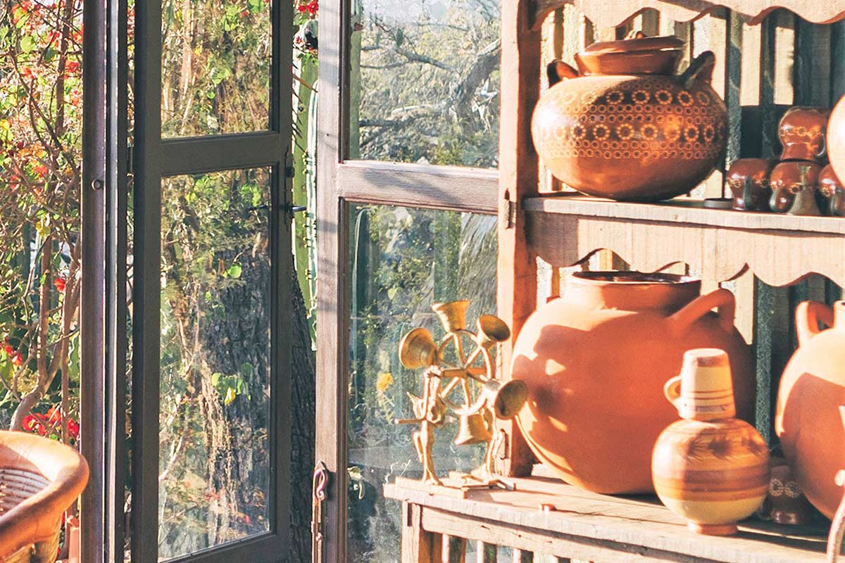 Sunny room with wooden shelf full of decorative pieces that are hard to declutter.