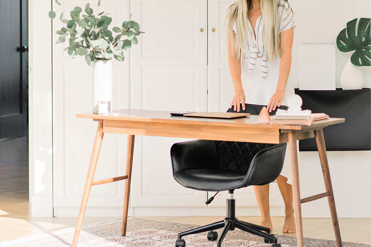 Clutter-free home office with desk and black chair.