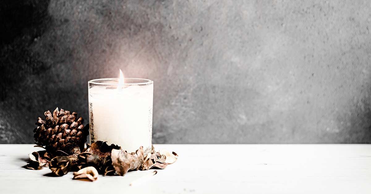 Featured moody image with candle for October creative writing prompts.