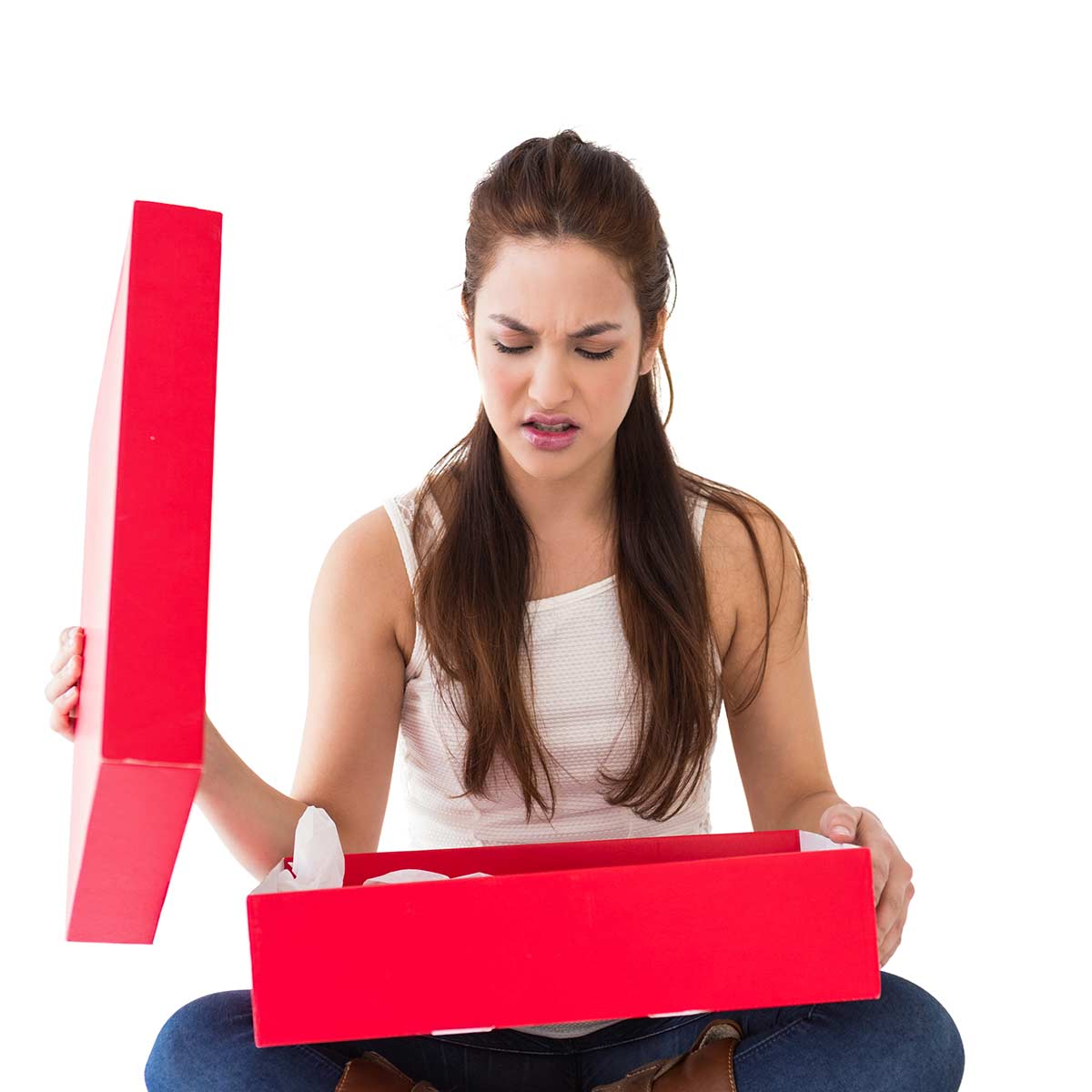 Woman with long dark hair staring in disbelief into an open red gift box.