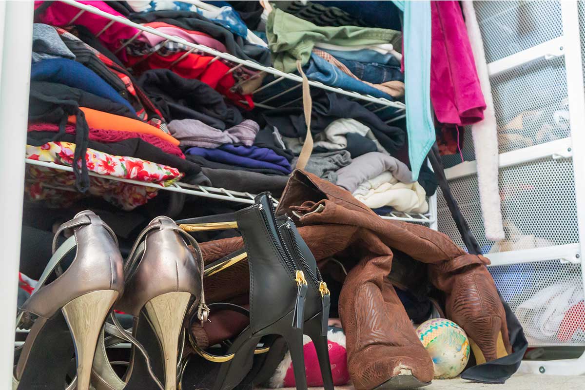 Extremely cluttered closet ready to be decluttered.