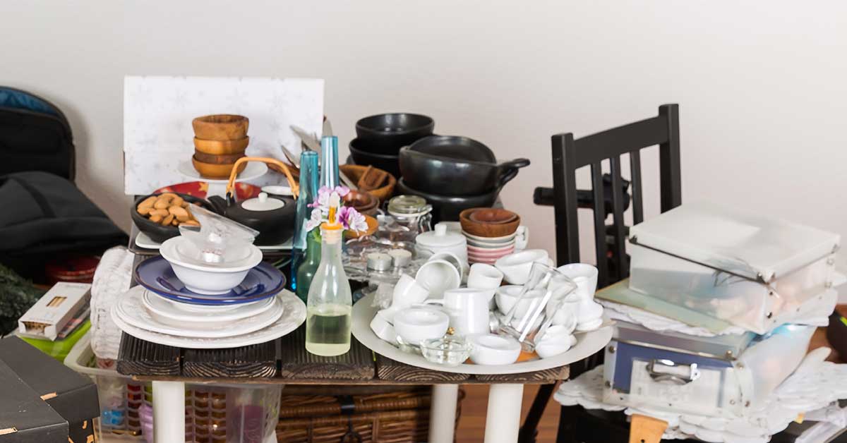 Clutter piled on table and chair.