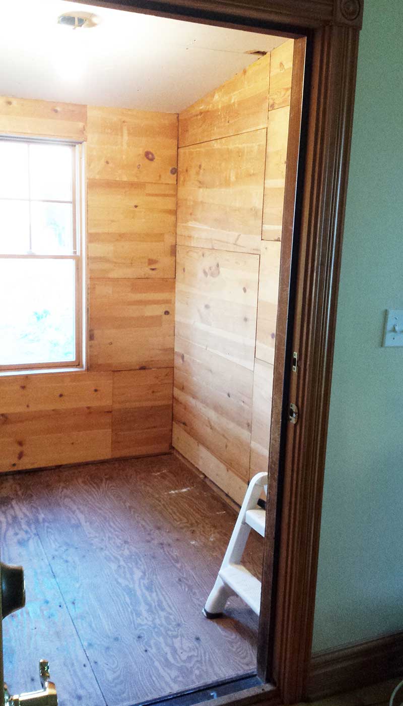 DIY entryway improvement begins with pine on the walls and drywall ceiling.