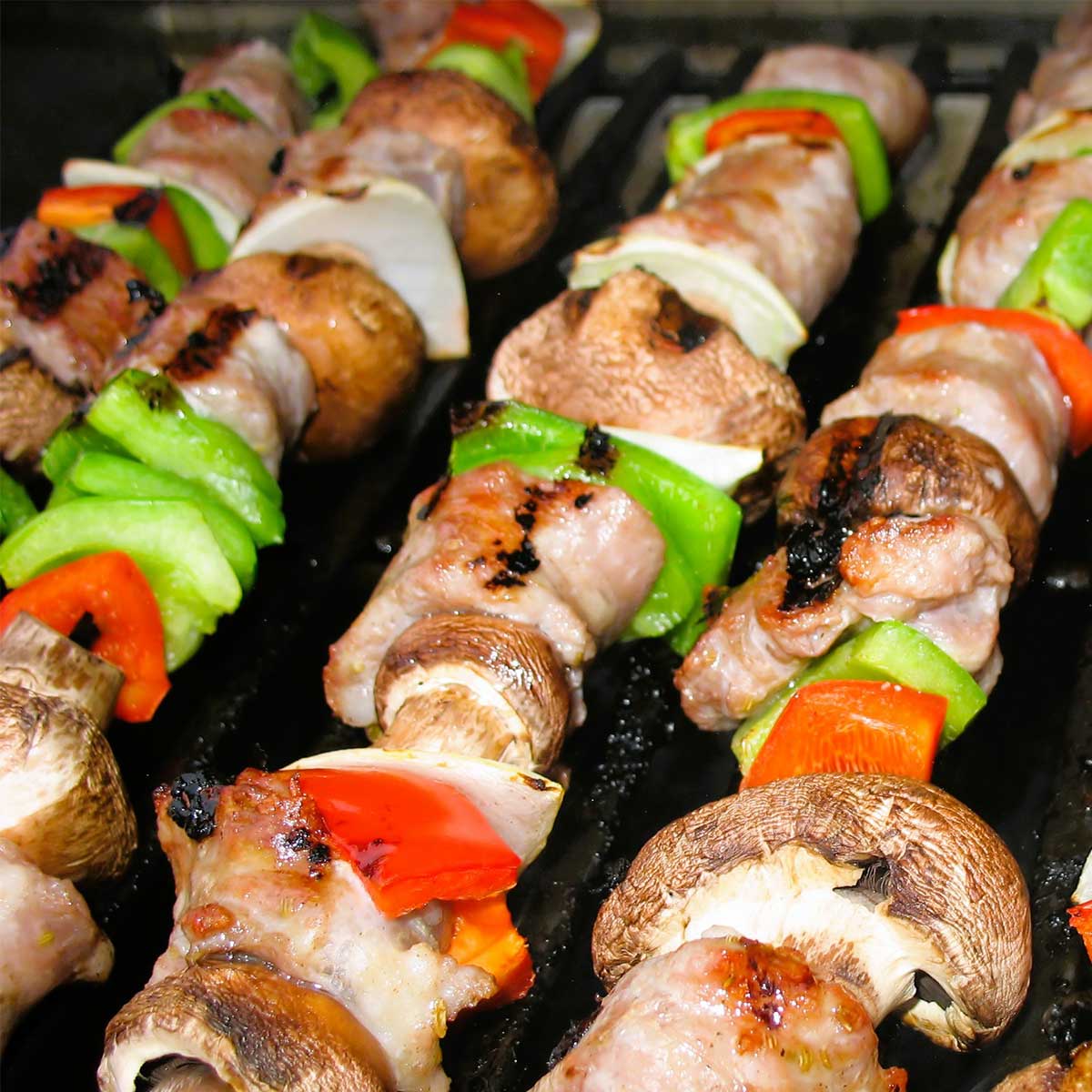 Sausage and vegetable kabobs on grill for August dinner.