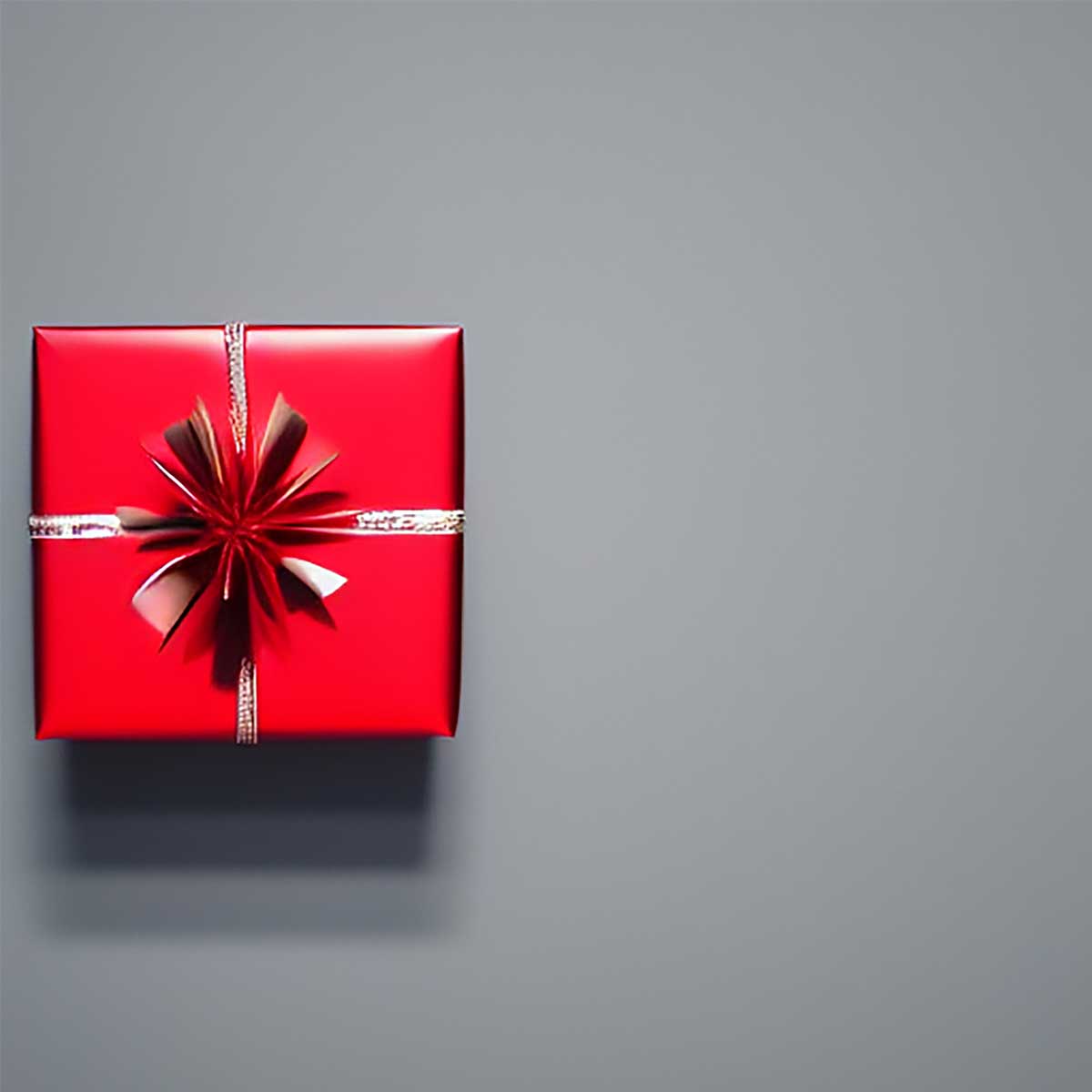 Red wrapped gift on dark gray background.