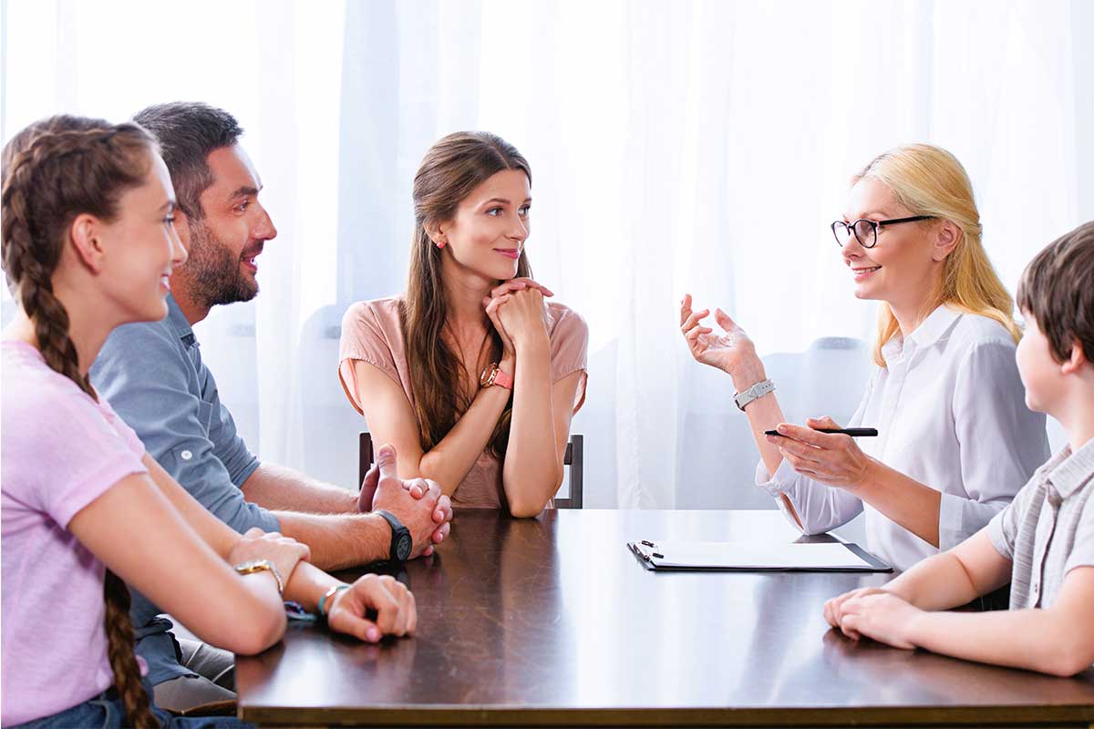 Family members sitting at table having a discussion.