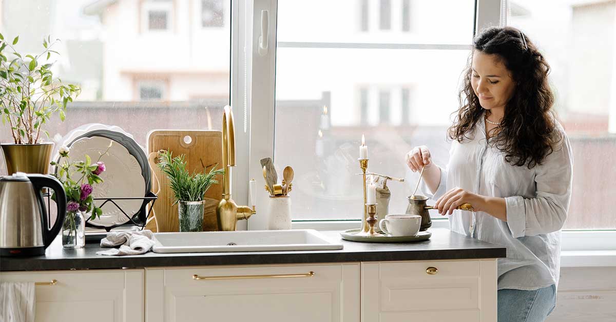 Sunday morning reset routine of enjoying a favorite beverage in a bright and modern white kitchen.