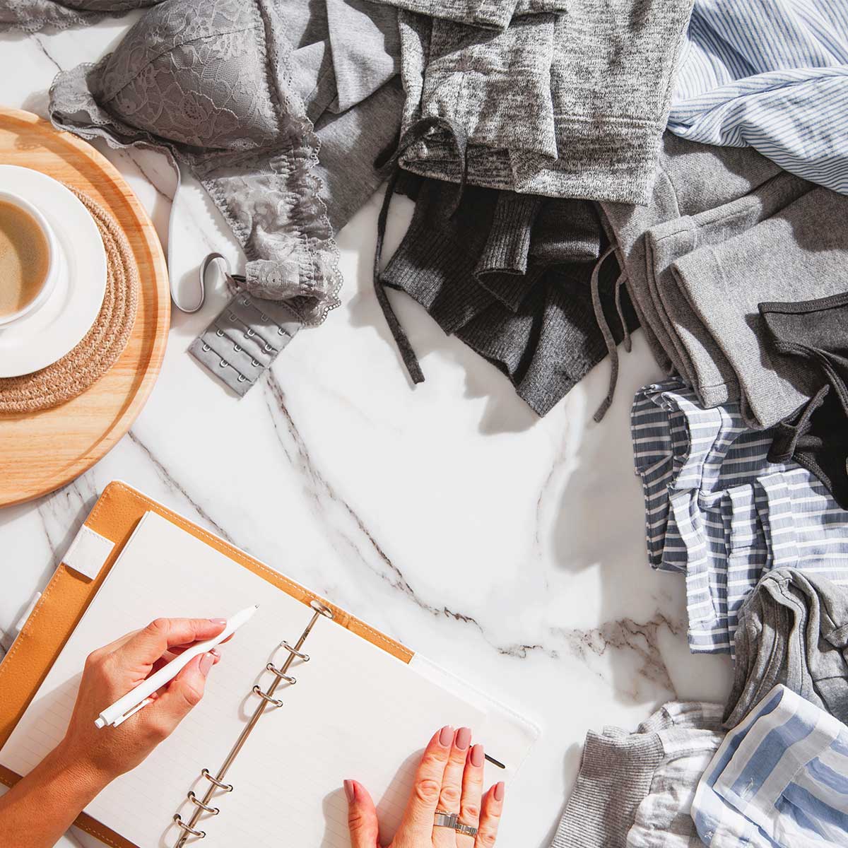 Woman with a planner preparing to sketch ideas for closet organizing.