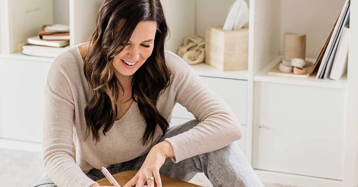 Woman with long dark hair and comfortable clothes confidently making decisions.