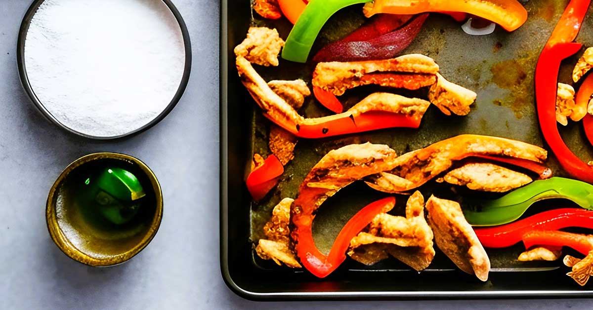 Sheet pan fajita ingredients on gray countertop.