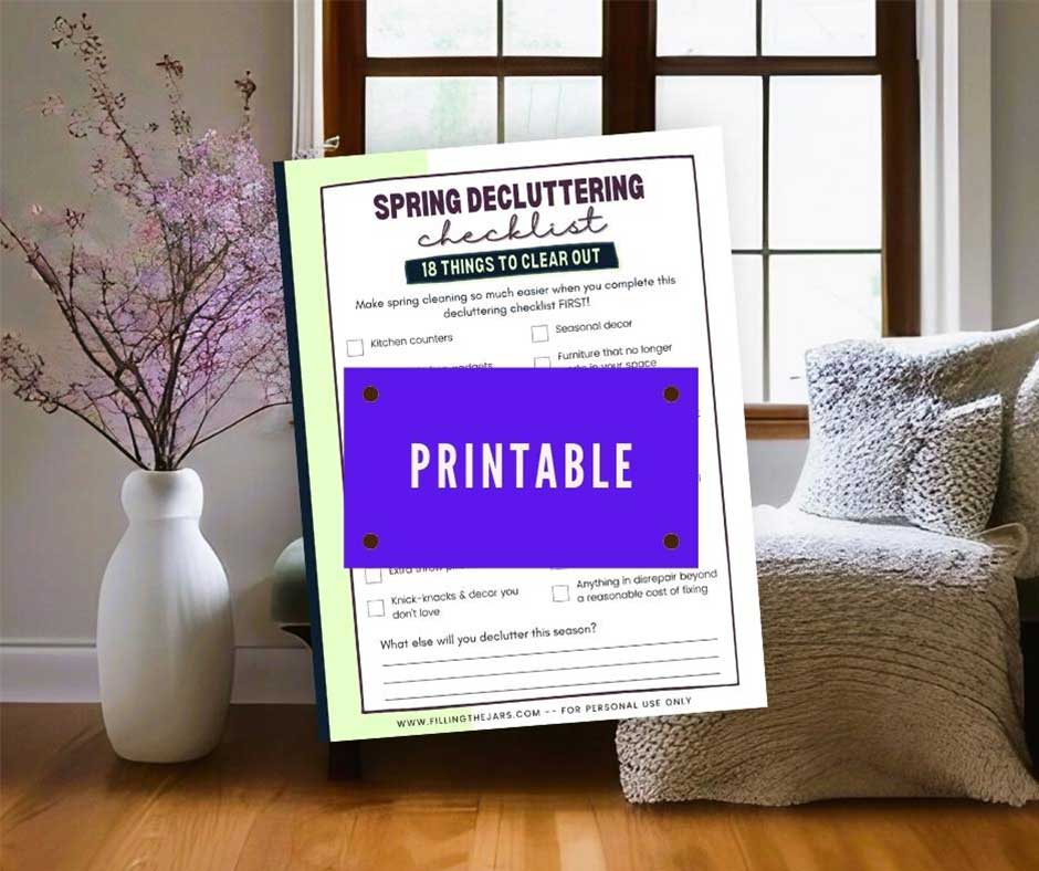 Mockup of printable spring decluttering checklist over background of bright simple room with flowers and bench in front of window.