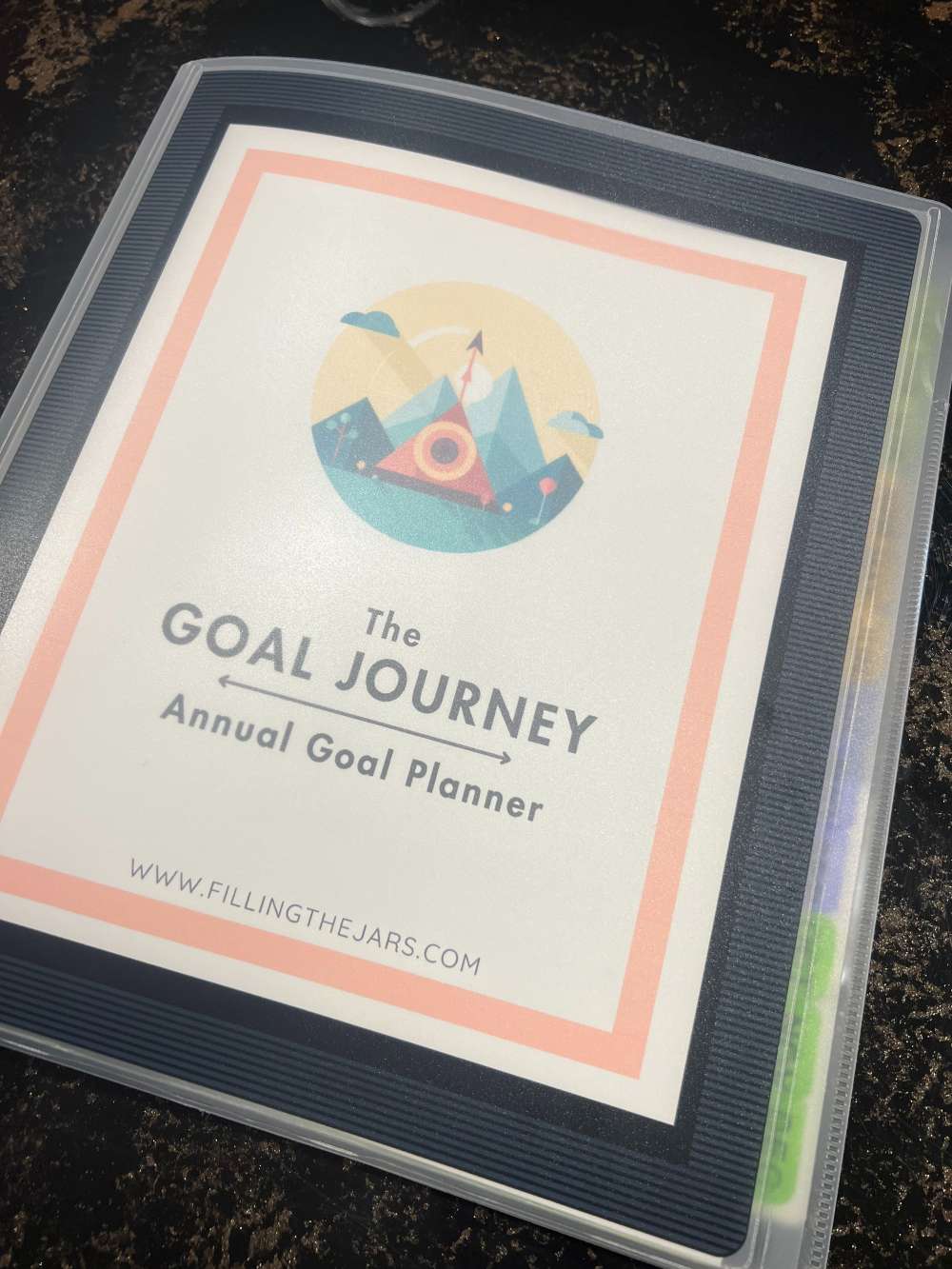 Printed cover of The Goal Journey Planner from Filling the Jars shown in the display cover of a flexible 3-ring binder.