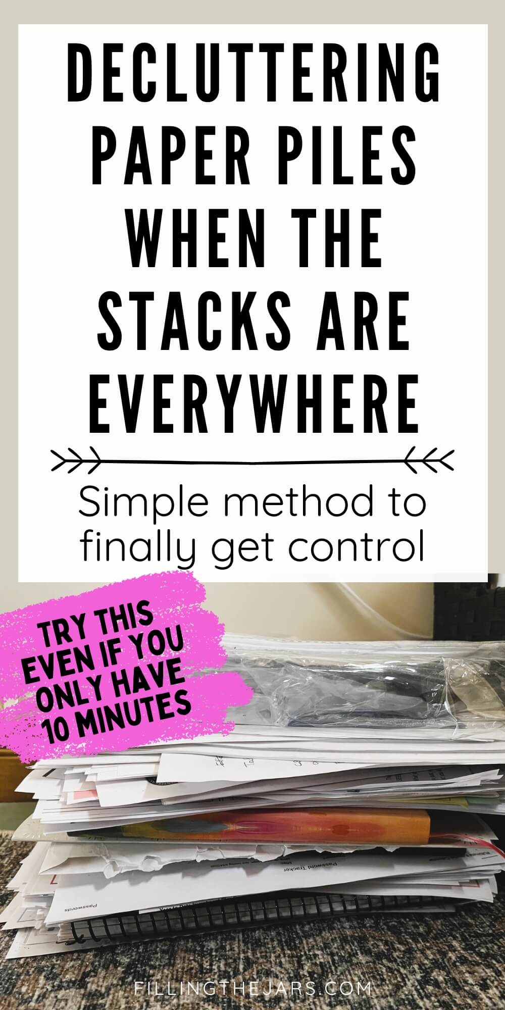 Stack of loose papers and folders piled high on the floor with bold overlay text that reads "Decluttering Paper Piles When The Stacks Are Everywhere" and "Simple method to finally get control" plus "Try This Even If You Only Have Only 10 Minutes."